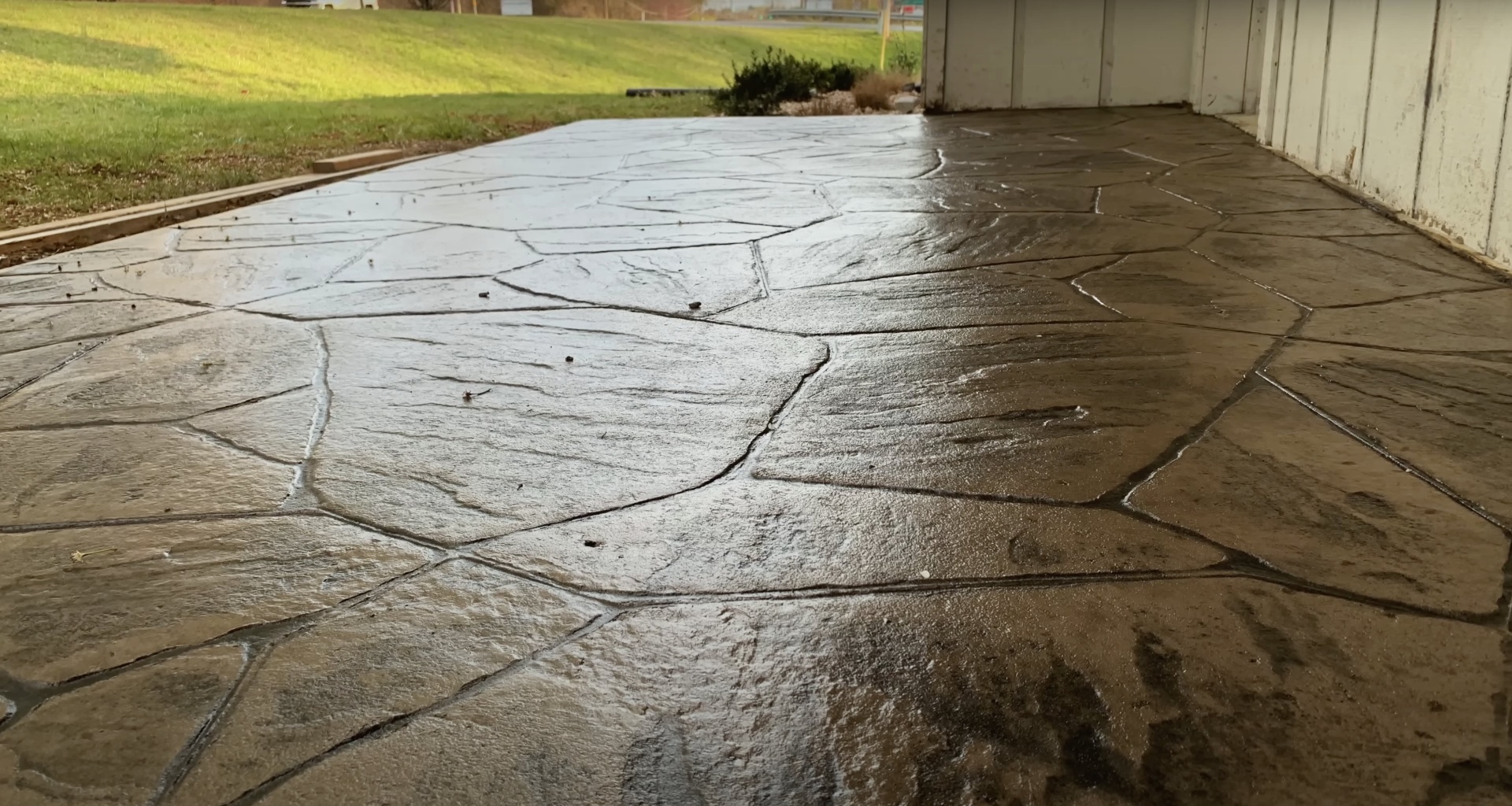 Stamped concrete patio with natural flagstone pattern demonstrating quality workmanship